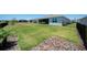 Expansive backyard with lush green grass and a view of the community, perfect for outdoor activities and relaxation at 8589 Saint Kitts Cir, Englewood, FL 34224