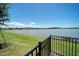 Private backyard view with lake and black fence, perfect for peaceful outdoor living at 8589 Saint Kitts Cir, Englewood, FL 34224