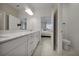 Bright bathroom with double vanity, large mirror and ample storage below and direct access to bedroom at 8589 Saint Kitts Cir, Englewood, FL 34224