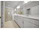Spacious bathroom with a double vanity, modern fixtures, and a large glass-enclosed shower at 8589 Saint Kitts Cir, Englewood, FL 34224