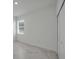 Neutral bedroom with tile floors, offering plenty of natural light from the window at 8589 Saint Kitts Cir, Englewood, FL 34224