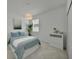 Well lit bedroom with bright walls, patterned bedding, and a large window at 8589 Saint Kitts Cir, Englewood, FL 34224