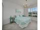 Bright bedroom featuring tile floors, decorative lighting and a serene view from the large window at 8589 Saint Kitts Cir, Englewood, FL 34224
