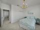 Tastefully decorated bedroom featuring tile floors, a modern chandelier and a tranquil ambiance at 8589 Saint Kitts Cir, Englewood, FL 34224