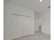 Spacious walk-in closet with a neutral color palette and convenient access to other rooms at 8589 Saint Kitts Cir, Englewood, FL 34224