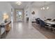 Bright and inviting foyer with tile flooring, modern lighting, and seamless transition into the dining area at 8589 Saint Kitts Cir, Englewood, FL 34224