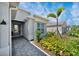 Inviting entryway featuring a patterned walkway, manicured landscaping and a covered entry to the home at 8589 Saint Kitts Cir, Englewood, FL 34224