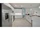 Modern kitchen featuring stainless steel appliances, white cabinets, and a stylish island with sink at 8589 Saint Kitts Cir, Englewood, FL 34224