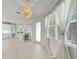 View of the open kitchen with stainless appliances, an island, and adjacent living area at 8589 Saint Kitts Cir, Englewood, FL 34224