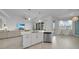 Stylish kitchen island with pendant lighting, stainless steel dishwasher, and open layout to the living area at 8589 Saint Kitts Cir, Englewood, FL 34224