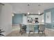 Open-concept kitchen with stainless steel appliances, white cabinets, and a convenient breakfast bar at 8589 Saint Kitts Cir, Englewood, FL 34224