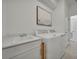 Bright laundry room featuring modern white appliances, a sink and tile flooring at 8589 Saint Kitts Cir, Englewood, FL 34224