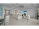 Expansive living room showcasing an open layout, neutral tones, and smooth transition to the dining and kitchen areas at 8589 Saint Kitts Cir, Englewood, FL 34224