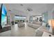 Comfortable living room with stylish furnishings, large windows, and open layout connecting to the kitchen at 8589 Saint Kitts Cir, Englewood, FL 34224