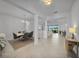 Spacious, open-concept living area with tile floors, bright white walls, and large windows with stunning views at 8589 Saint Kitts Cir, Englewood, FL 34224