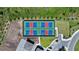 Aerial view of community tennis courts surrounded by lush greenery, highlighting recreational amenities at 8589 Saint Kitts Cir, Englewood, FL 34224
