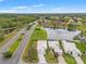 Aerial view showcasing homes with screened pools and scenic pond in a residential neighborhood at 9188 Rhett Ln, Weeki Wachee, FL 34613