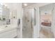Well-lit bathroom features a shower and white vanity with sink at 9188 Rhett Ln, Weeki Wachee, FL 34613
