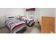 Bright bedroom with two twin beds and a window with natural light at 9188 Rhett Ln, Weeki Wachee, FL 34613