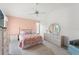 Bright bedroom features a ceiling fan, closet, and neutral-toned walls at 9188 Rhett Ln, Weeki Wachee, FL 34613