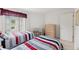 Bright bedroom featuring two twin beds, a desk, a dresser, and a window providing natural light at 9188 Rhett Ln, Weeki Wachee, FL 34613