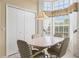 Sunlit breakfast nook features a bay window and comfortable seating at 9188 Rhett Ln, Weeki Wachee, FL 34613