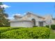 Charming single-story home featuring lush landscaping and a light-colored roof at 9188 Rhett Ln, Weeki Wachee, FL 34613
