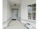 Inviting front porch with neutral colored door, a decorative hanging lantern, and a ceramic turtle planter at 9188 Rhett Ln, Weeki Wachee, FL 34613