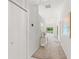 Bright hallway with carpet, closet, and a view of the outdoor seating area at 9188 Rhett Ln, Weeki Wachee, FL 34613