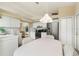 Bright eat-in kitchen features white cabinets, stainless steel appliances, and adjacent living space at 9188 Rhett Ln, Weeki Wachee, FL 34613