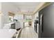 Bright kitchen featuring white cabinets, stainless steel appliances, and a view of the living room at 9188 Rhett Ln, Weeki Wachee, FL 34613