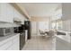 Eat-in kitchen with black appliances, a neutral color palette, and bright lighting at 9188 Rhett Ln, Weeki Wachee, FL 34613