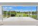 Screened lanai with a table overlooking green space at 9188 Rhett Ln, Weeki Wachee, FL 34613