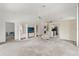 Living room featuring built-in shelving, a ceiling fan, and easy access to the kitchen at 9188 Rhett Ln, Weeki Wachee, FL 34613
