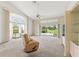 Spacious living room with a ceiling fan, large windows and a sliding glass door leading to the patio at 9188 Rhett Ln, Weeki Wachee, FL 34613