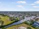 Scenic aerial view of a residential area with a river, golf course, and interconnected canals at 925 Eagle Ln, Apollo Beach, FL 33572