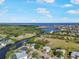 An aerial view showcases beautiful waterways with homes, landscaping, and access to the ocean at 925 Eagle Ln, Apollo Beach, FL 33572