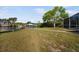 A back yard featuring a grass lawn, a boat dock and a screened enclosure at 925 Eagle Ln, Apollo Beach, FL 33572