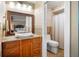 Bathroom featuring granite counters, wood cabinets, and a walk in shower at 925 Eagle Ln, Apollo Beach, FL 33572