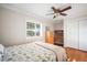 Cozy bedroom with hardwood floors, a ceiling fan, a built-in desk, and a double-door closet at 925 Eagle Ln, Apollo Beach, FL 33572