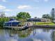 Waterfront property with a private dock, featuring a boat lift and screened-in lanai at 925 Eagle Ln, Apollo Beach, FL 33572
