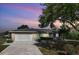 Charming single-story home with a well-maintained lawn, mature trees, and a two-car garage at 925 Eagle Ln, Apollo Beach, FL 33572