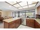 Well-lit kitchen with granite countertops, stainless steel appliances, wood cabinets, and a large window with a view at 925 Eagle Ln, Apollo Beach, FL 33572