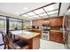 Spacious kitchen featuring granite countertops, stainless steel appliances, and a large window with backyard views at 925 Eagle Ln, Apollo Beach, FL 33572