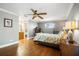Spacious main bedroom featuring a ceiling fan, hardwood floors, and an adjacent bathroom at 925 Eagle Ln, Apollo Beach, FL 33572