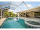 Enclosed pool and spa featuring an outdoor dining area and fan providing ultimate relaxation at 925 Eagle Ln, Apollo Beach, FL 33572