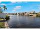 Picturesque waterfront homes line a tranquil canal under a bright, partly cloudy sky at 925 Eagle Ln, Apollo Beach, FL 33572