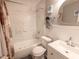 Bathroom with a tub and shower combination, and a single sink vanity with lots of lighting at 10233 N Valle Dr, Tampa, FL 33612