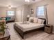 Comfortable bedroom featuring a queen bed, sitting area, and bright windows at 10233 N Valle Dr, Tampa, FL 33612