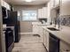 Modern kitchen with white cabinets, stainless steel appliances, and stylish backsplash at 10233 N Valle Dr, Tampa, FL 33612
